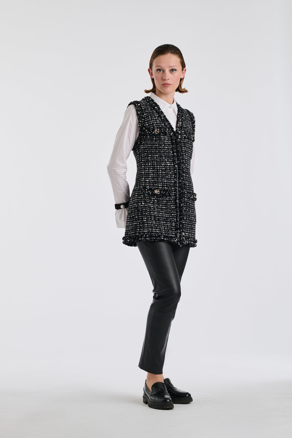 Two-tone sleeveless jacket in fringed tweed