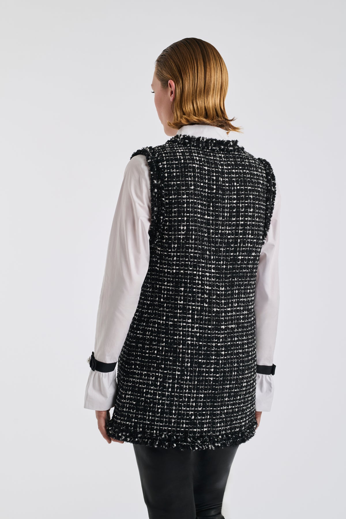 Two-tone sleeveless jacket in fringed tweed