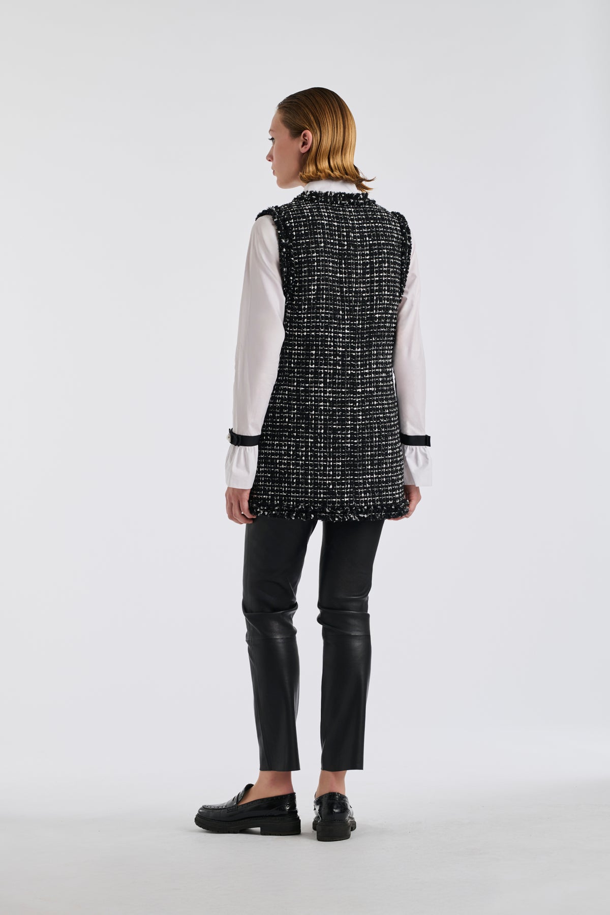Two-tone sleeveless jacket in fringed tweed