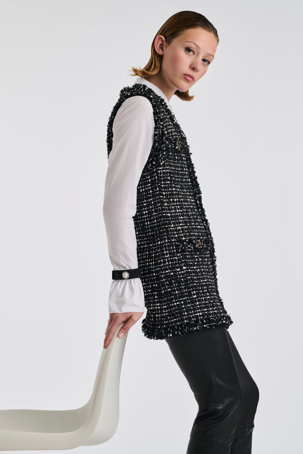 Two-tone sleeveless jacket in fringed tweed