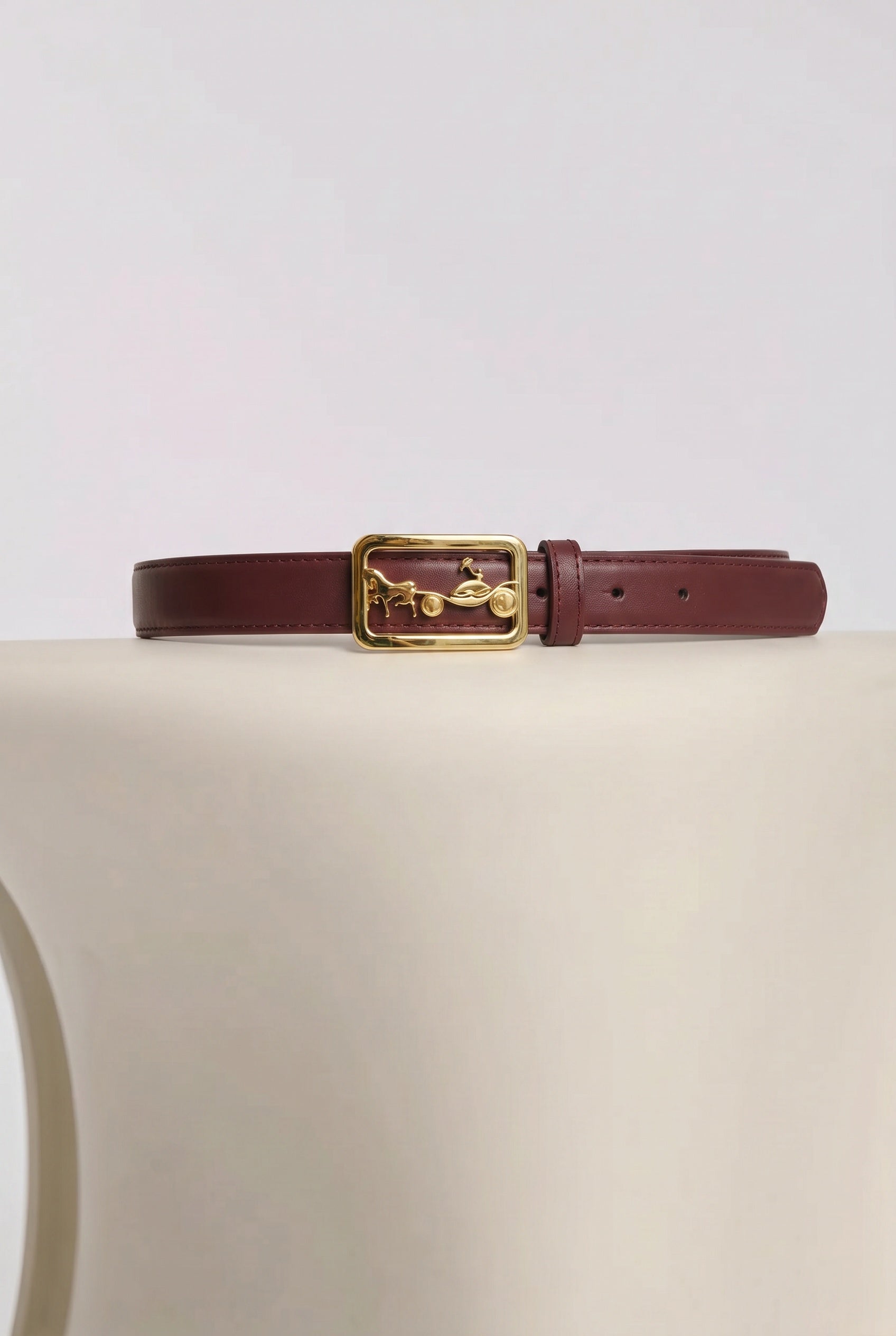 Leather belt with a carriage-style buckle